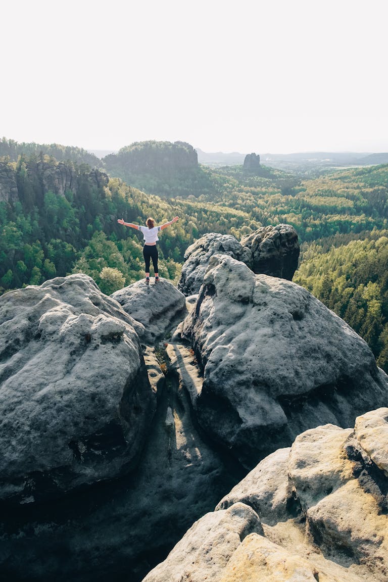 Woman Standing on Rock Formation in Elbe Sandstone Mountains in Germany